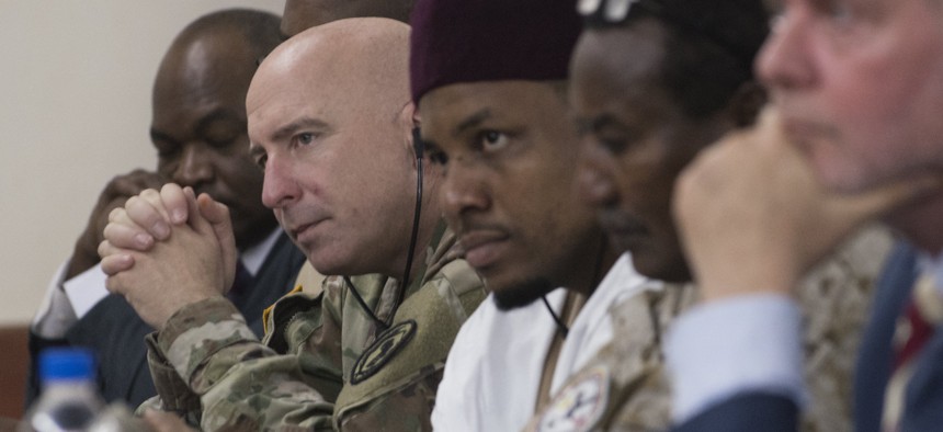 NIAMEY, Niger - Lt. Col. Charles Lewis, defense attaché, U.S. Embassy Niamey, alongside representatives from partner nations Chad and Denmark, listens to opening remarks made at the Senior Leadership Seminar for Flintlock 2018 in Niamey Niger Apr. 9, 2018