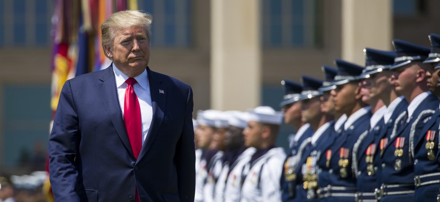 In this July 25, 2019, file photo, President Donald Trump reviews the troops during a full honors welcoming ceremony for Secretary of Defense Mark Esper at the Pentagon in Washington.
