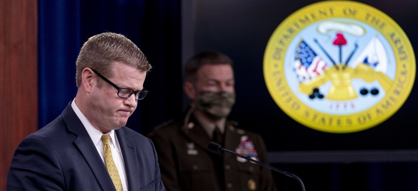 Secretary of the Army Ryan McCarthy, left, accompanied by Gen. James McConville, Chief of Staff of the Army, right, pauses while speaking about an investigation into Fort Hood, Texas at the Pentagon, Dec. 8, 2020, in Washington.