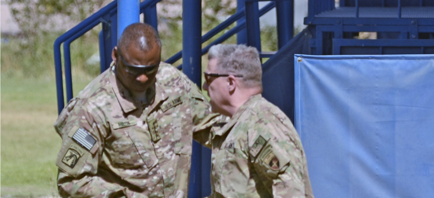 Then-U.S. Army Lt. Gen. Mark Milley, commander of International Security Assistance Force-Joint Command, greets then-Gen. Lloyd Austin, commander of U.S. Central Command, in Kabul, Afghanistan, in 2013.