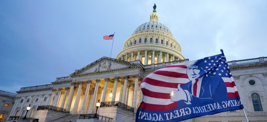 After storming the Capitol Building in a riot, Trump supporters left a flag outside the Capitol, Wed., Jan. 6, 2021, in Washington.