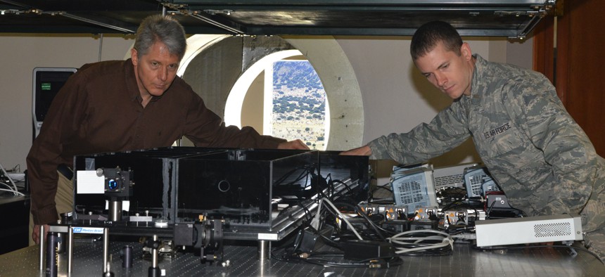 Air Force Research Laboratory researchers Mark Gruneisen and 2nd Lt. Eddie Hilburn make adjustments to the quantum key distribution testbed at the Starfire Optical range propagation site in 2019.