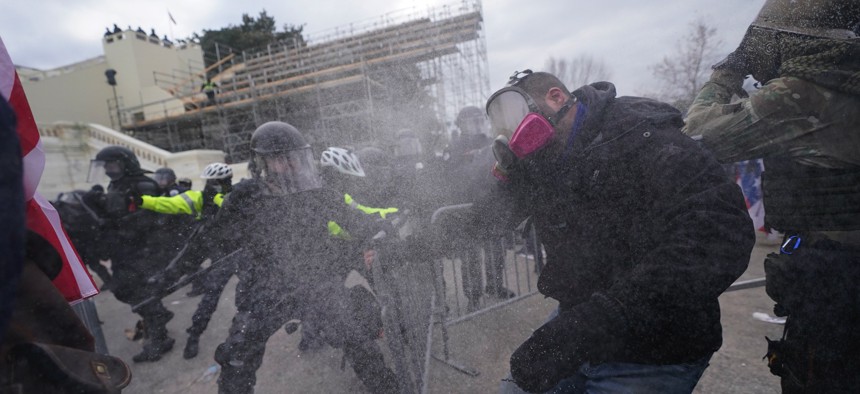 Trump supporters try to break through a police barrier, Wednesday, Jan. 6, 2021, at the Capitol in Washington.