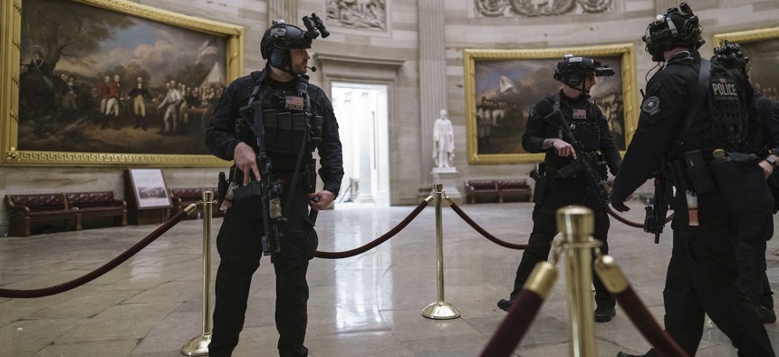 Members of the U.S. Secret Service Counter Assault Team walk through the Rotunda as they and other federal police forces responded as violent protesters loyal to President Donald Trump stormed the U.S. Capitol today, Wednesday.