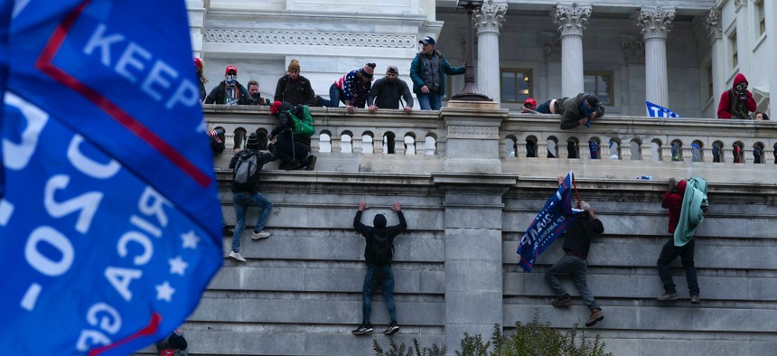 Trump supporters try to break through a police barrier, Wednesday, Jan. 6, 2021, at the Capitol in Washington.
