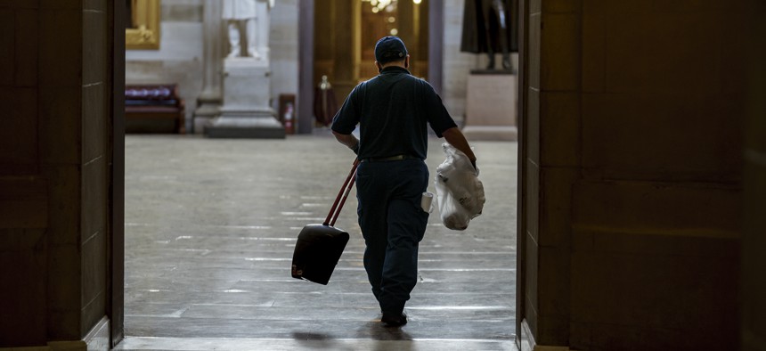 A workman walks through the Rotunda after cleaning debris outside the office of Speaker of the House Nancy Pelosi on the day after violent protesters loyal to President Donald Trump stormed the U.S. Congress.