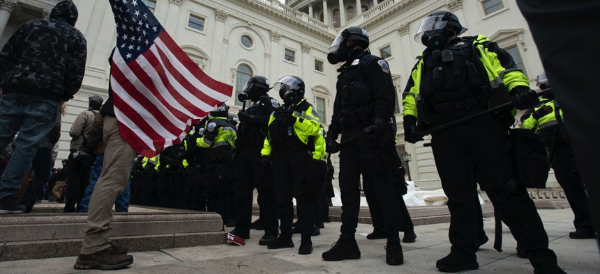 U.S. Capitol Police officers push back demonstrators who were trying to break into the U.S. Capitol on Wednesday, Jan. 6, 2021, in Washington.