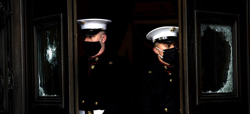 U.S. Marine Corps. hold the damaged Capitol doors during a rehearsal for the 59th inaugural ceremony for President-elect Joe Biden and Vice President-elect Kamala Harris on Monday, Jan. 18, 2021 at the U.S. Capitol in Washington.