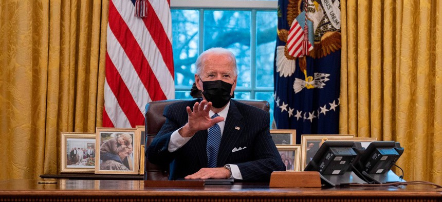 President Joe Biden speaks with Secretary of Defense Lloyd Austin (R) in the Oval Office of the White House in Washington, DC, on January 25, 2021.