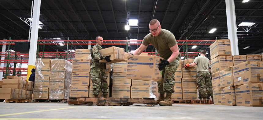 Members of the Maryland Air National Guard prepare medical supplies for transport at the Maryland Strategic National Stockpile location on March 19, 2020.