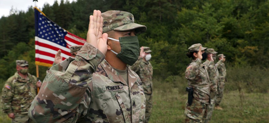 Soldiers from the U.S. Army National Guard and U.S. Army Reserve participate in a reenlistment ceremony Sept. 26, 2020, near Ferizaj/Urosevac, Kosovo.