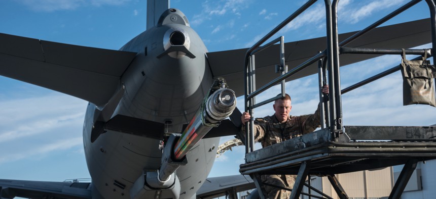 Master Sgt. Chris Hughes, 22nd Maintenance Squadron hydraulics craftsman, climbs onto a B4 stand to begin an acceptance inspection on a KC-46A Pegasus boom Feb. 14, 2019, at McConnell Air Force Base.
