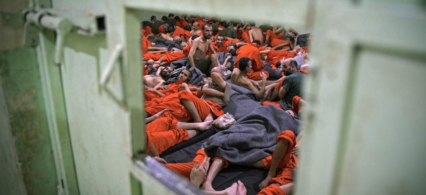 Men, suspected of being affiliated with the Islamic State (IS) group, gather in a prison cell in the northeastern Syrian city of Hasakeh on October 26, 2019. 