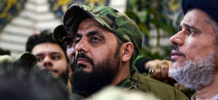 Qais al-Khazali (C) commander of the Asaib Ahl al-Haq pro-Iran faction attends the funeral procession of slain Iraqi paramilitary chief Abu Mahdi al-Muhandis in January 2020.