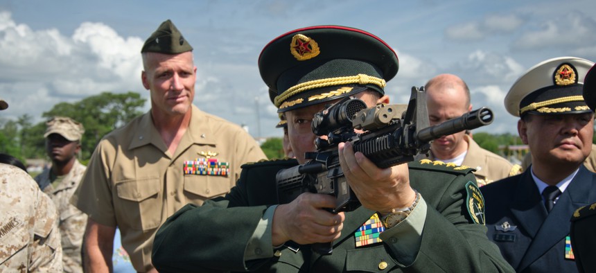 One of the general officers accompanying China's Minister of National Defense shoulders an M4 carbine during a 2012 visit to Marine Corps Base Camp Lejeune, N.C.