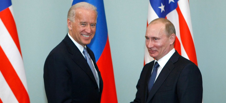 Then-Vice President Biden, left, shakes hands with Russian Prime Minister Vladimir Putin in Moscow, Russia, in March 2011. 