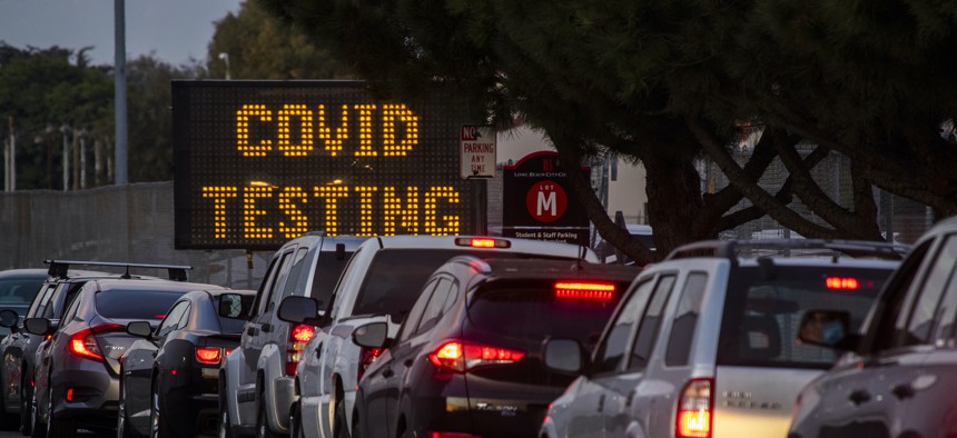 Drivers line up to take COVID-19 tests on Dec. 9, 2020 in Long Beach, Calif.