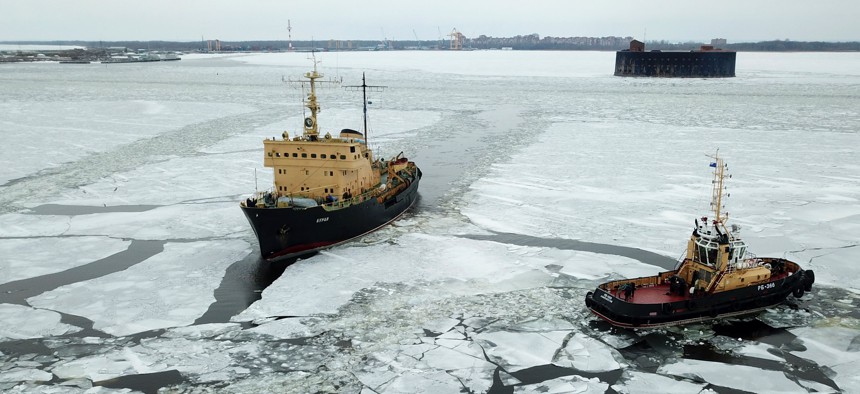 Russia's RB-366 tugboat and the Buran diesel-electric icebreaker break ice in the Gulf of Finland.