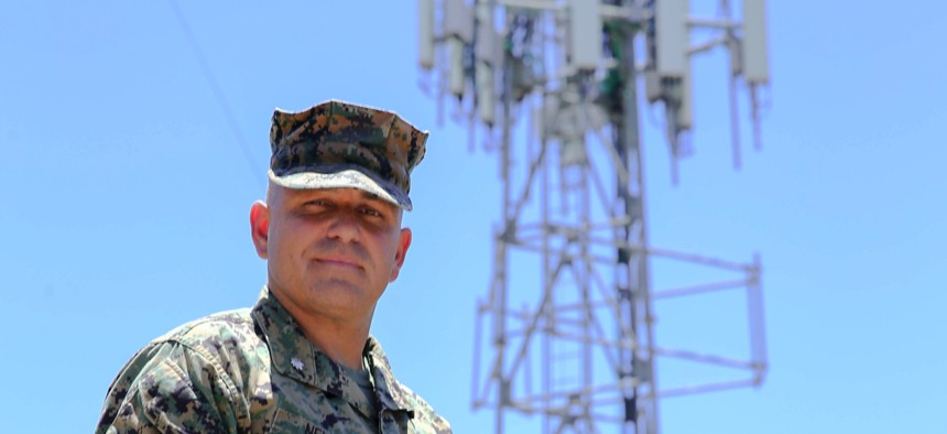 Lt. Col. Brandon Newell, Director of Technology and Partnerships for the Marine Corps Installation Next program poses in front of the new 5G tower installed by Verizon at MCAS Miramar on July 15, 2020.