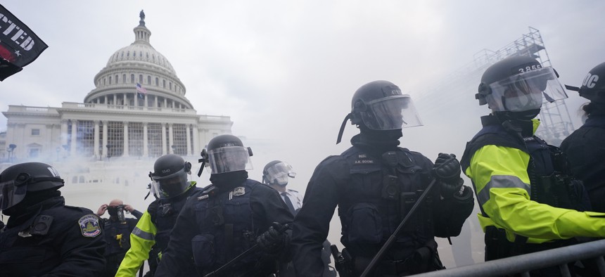 Police stand guard Jan. 6, 2021, after holding off violent rioters who tried to break through a police barrier at the Capitol in Washington. 