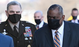 Chairman of the Joint Chiefs of Staff Gen. Mark Milley, left, looks on as Defense Secretary Lloyd Austin arrives at the Pentagon.