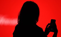 A guest takes a selfie with her smartphone during the Mercedes Benz Fashion Week in Madrid on April 8, 2021