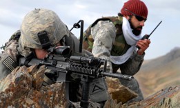In this 2009 photo, U.S. Army 1st Lt. Jared Tomberlin, left, and an interpreter pull security on top of a mountain ridge during a reconnaissance mission near Forward Operating Base Lane in the Zabul province of Afghanistan.
