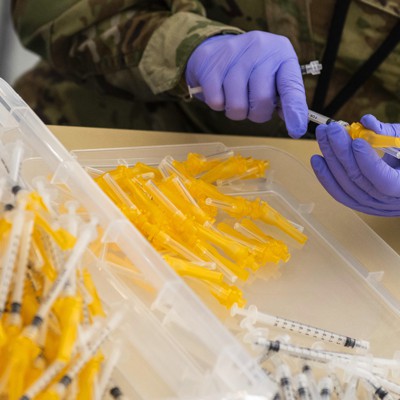                      An airman assembles COVID-19 vaccine syringes.                                         DOD                     As roughly half of