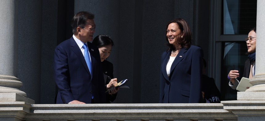 U.S. Vice President Kamala Harris (R) and Korean President Moon Jae-in (L) look at the White House from a balcony of the Eisenhower Executive Office Building on May 21, 2021.