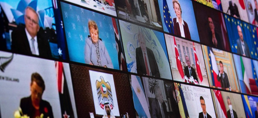 World leaders are seen on a screen during a climate change virtual summit from the East Room of the White House campus April 22, 2021, in Washington, DC.