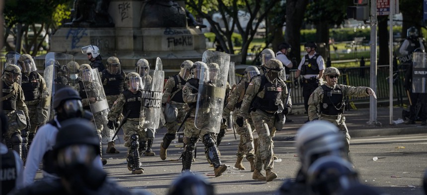 Law enforcement responds during a protest near Lafayette Park ahead of President Trump's trip to St. John's Church on June 1, 2020.