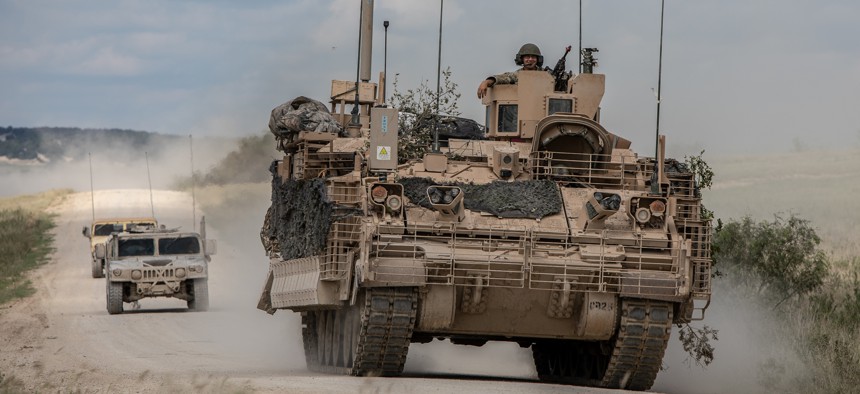 Soldiers are escorted by observer controllers from the U.S. Army Operational Test Command after completing field testing of the Armored Multi-Purpose Vehicle (AMPV) September 24, 2018.