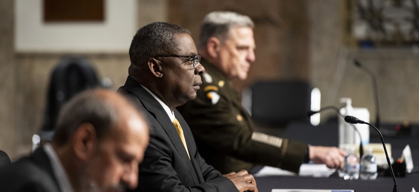 From left, Under Secretary of Defense Michael McCord, Secretary of Defense Lloyd Austin III, and Chairman of The Joint Chiefs Of Staff General Mark Milley prepare to testify during the Senate Armed Services Committee hearing on the Defense Authorization Request for fiscal year 2022 on Thursday, June 10, 2021.