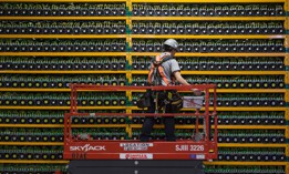 A technician inspects the backside of bitcoin mining at Bitfarms in Saint Hyacinthe, Quebec on March 19, 2018.