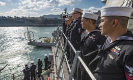 Sailors aboard the Arleigh Burke-class guided-missile destroyer USS Stethem man the rails as the ship enters port in Busan, South Korea, Oct. 21, 2017. 