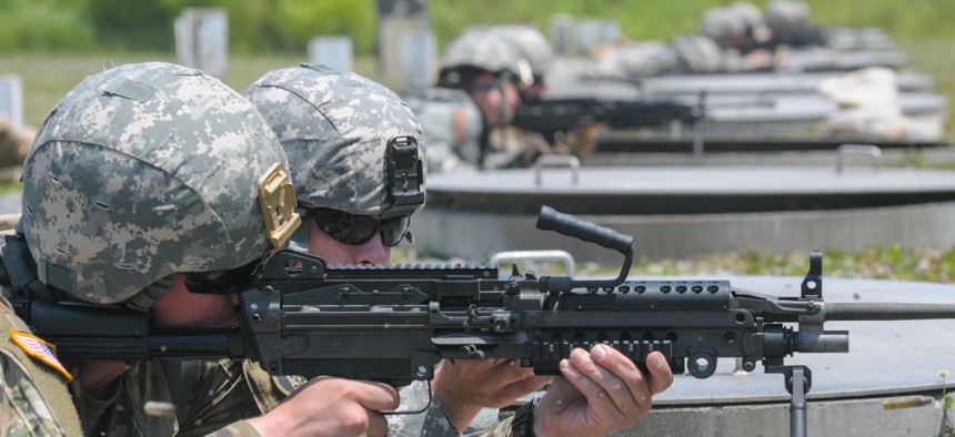 A soldier with the 1229th Transportation Company, Maryland Army National Guard, fires an M249 light machine gun during the unit’s annual training at Camp Dawson, West Virginia, on June 11, 2016. 
