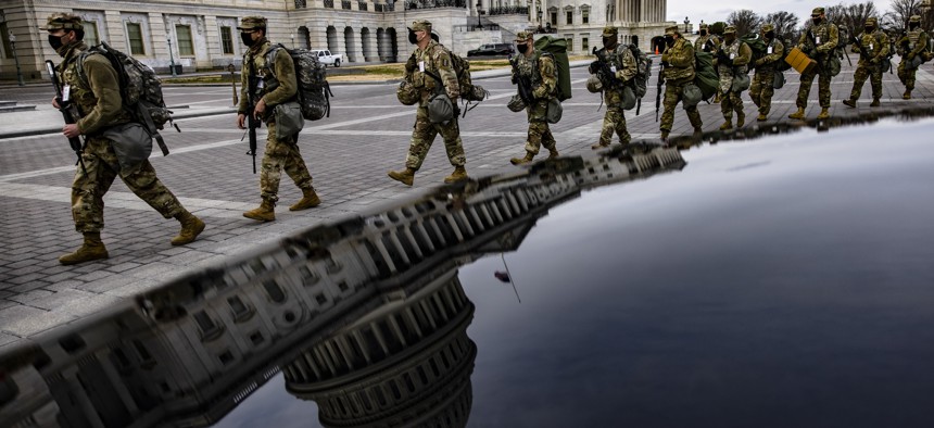 Virginia National Guard soldiers march across the U.S. Capitol on their way to their guard posts on January 16, 2021, in Washington, DC. 
