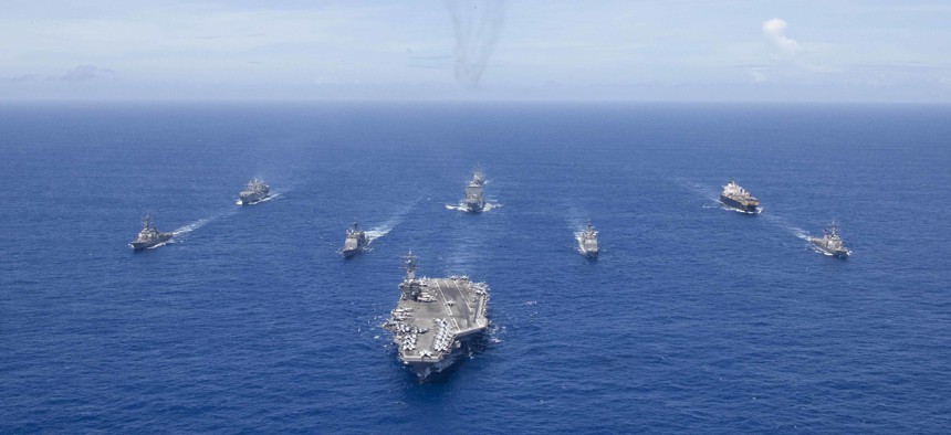 USS Ronald Reagan (CVN 76) leads a formation of Carrier Strike Group 5 ships during Valiant Shield 2018.