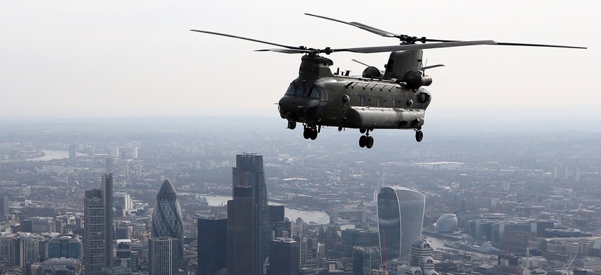 A Royal Air Force Chinook helicopter flies over the city's center as a memorial service to mark the end of Britain's combat operations is held at St Paul's Cathedral in central London on March 13, 2015.