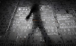 A picture taken on October 17, 2016 shows an employee walking behind a glass wall with machine coding symbols at the headquarters of Internet security giant Kaspersky in Moscow.