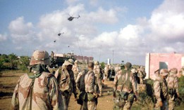 Army soldiers of Company B, 2nd Battalion, 14th Infantry Regiment, watch helicopter activity over Mogadishu, Oct. 3, 1993. Later the same day and throughout the night, the battalion's A and C Companies were part of a rescue convoy assembled for nearly 100 Rangers who had become trapped in the city after two Black Hawks were shot down.