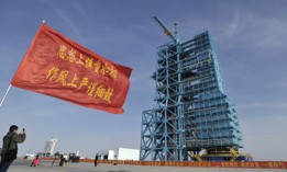 A man takes a photo of an upgraded Long March 2F rocket carrying the Shenzhou-8 spacecraft at the Jiuquan Satellite Launch Center in Jiuquan, northwest China's Gansu province, on October 31, 2011. 