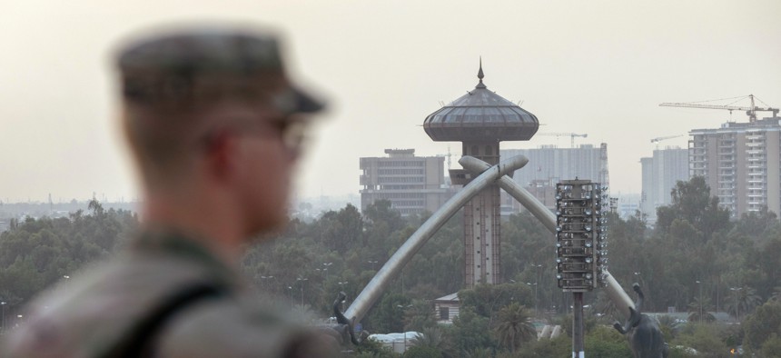 A U.S. Army soldier looks onto Baghdad and the Saddam-era Crossed Sabers monument from the International Zone on May 30, 2021.