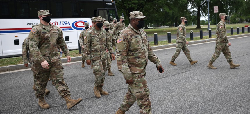 National Guard troops arrive at the DC Armory on May 24, 2021, after ending their mission of providing security to the U.S. Capitol.