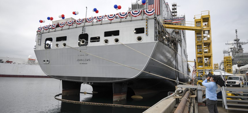 A television cameraman videotapes the USNS John Lewis before a christening ceremony on July 17, 2021, in San Diego. 