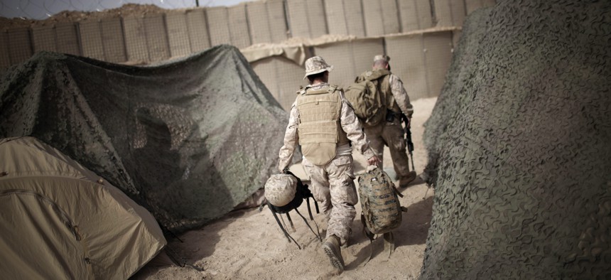 An interpreter follows a U.S. Marine officer prior to moving to another military base in Marjah, Helmand province, southern Afghanistan, on March 21, 2010. 
