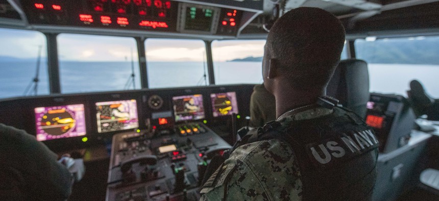 Chief Master-at-Arms Cornelius Johnson stands watch on the bridge aboard the Spearhead-class expeditionary fast transport USNS City of Bismarck, during Pacific Partnership 21. 