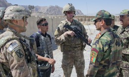 Sgt. 1st Class Jeremiah Velez, left, and Capt. David Zak, center, both advisors with the 1st Security Force Assistance Brigade's 3rd Squadron, speak with their Afghan National Army counterparts during a fly-to-advise mission at Forward Operating Base Altimur, Afghanistan, Sept. 19, 2018. 
