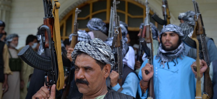 Afghan militia gather with their weapons to support Afghanistan security forces against the Taliban, in Afghan warlord and former Mujahideen leader Ismail Khan’s house in Herat on July 9, 2021. 