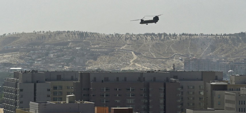 A US military helicopter is pictured flying above the US embassy in Kabul on August 15, 2021.